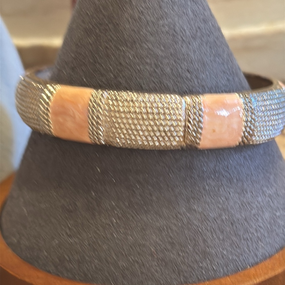Rigid textured silver tone and pale pink enamel hinged bracelet